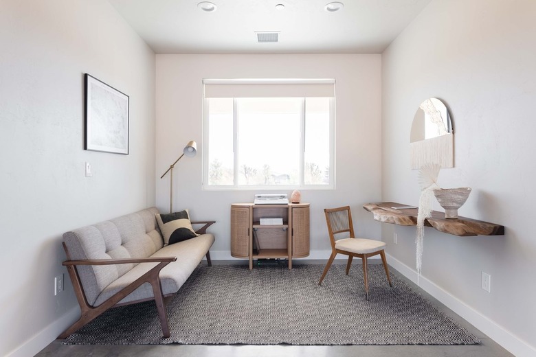 Minimalist living room with a gray and neutral theme, wood furniture, and organic decor.