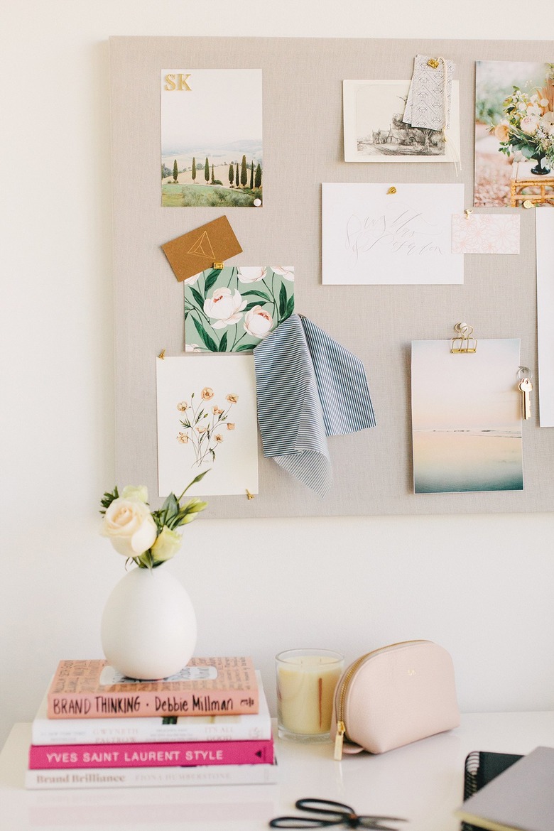 fabric pinboard with pieces of inspiration in white home office