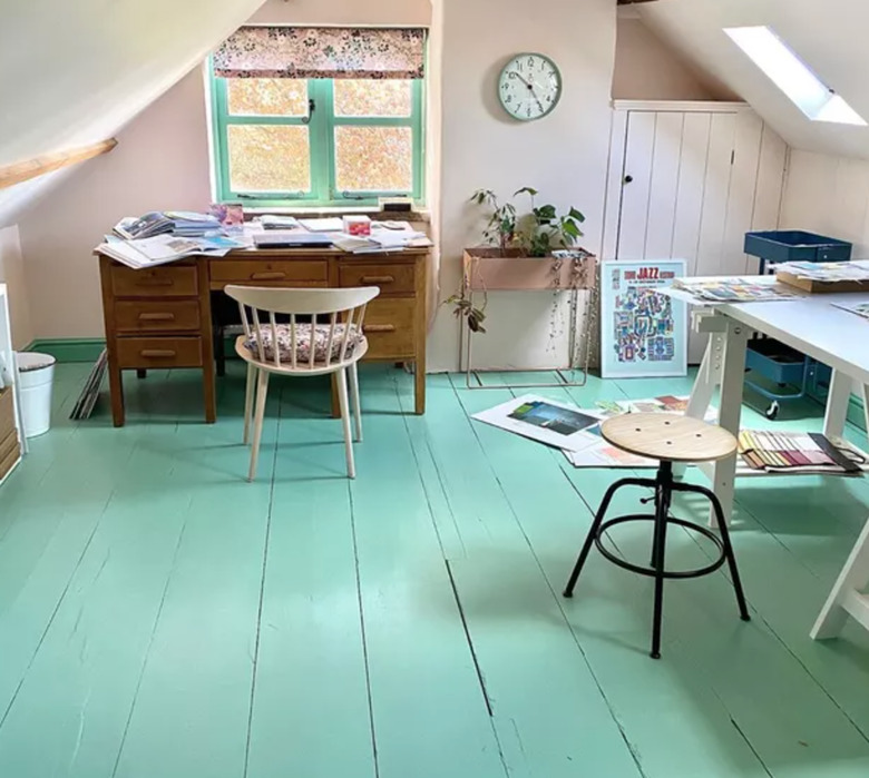 Home Office for Two Attic office with painted turquoise wood floors, vintage desk, stool, wall clock.