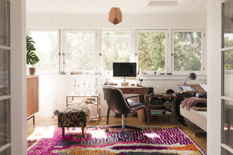 home office in living room idea with sun shining in the window