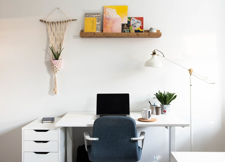 White office area with macrame plant holder and shelf