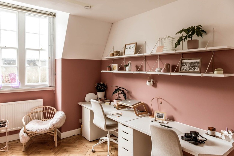 pink home office with white furniture near window