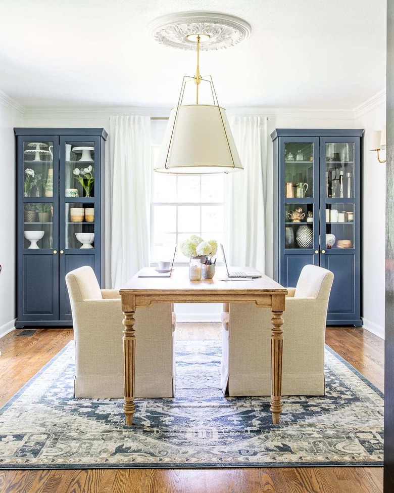 class home office with dining table and pendant light with drum shade