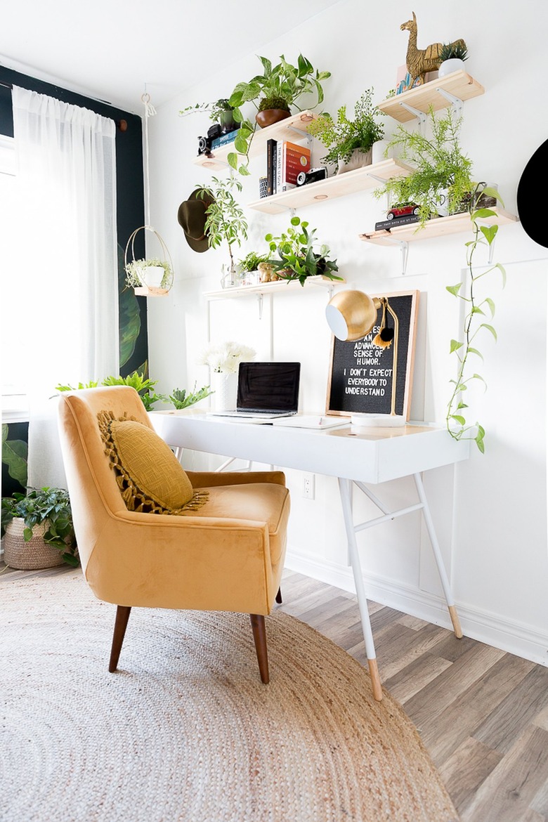 wood shelving arrangement filled with greenery and decor