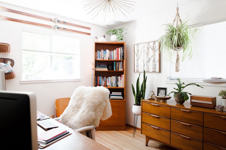 midcentury home office with wood furniture and potted plants