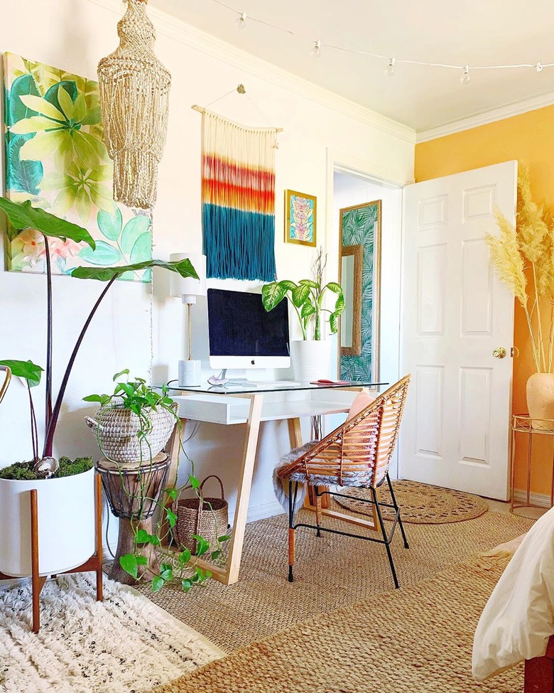 a colorful boho office with a yellow accent wall