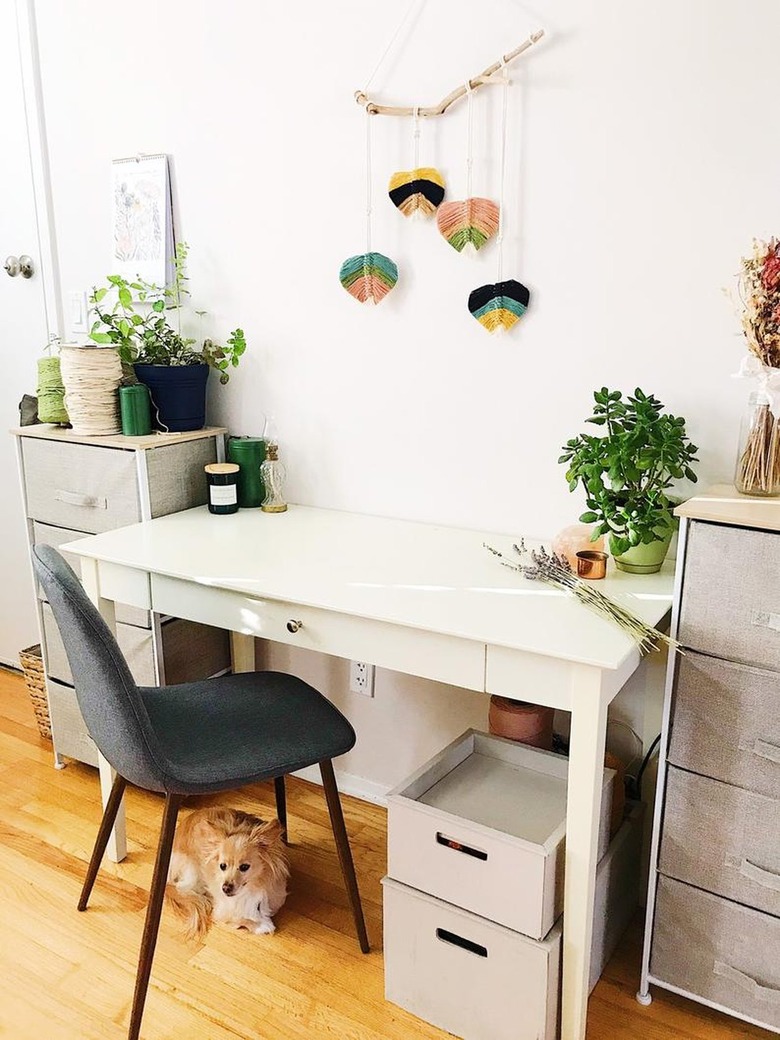 white and grey office with colorful wall-hanging