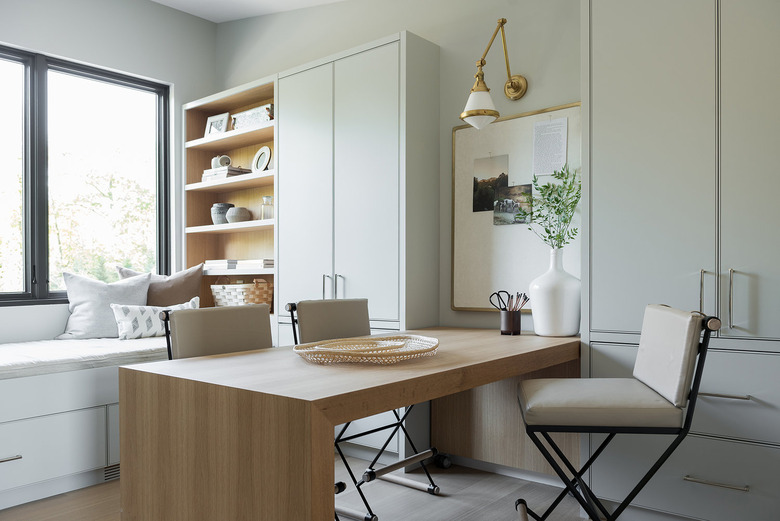 brass and glass wall sconce in neutral modern home office