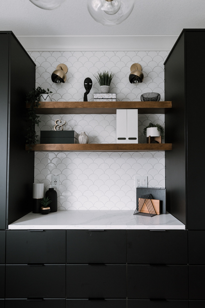 black and brass contemporary wall sconces in black and white office