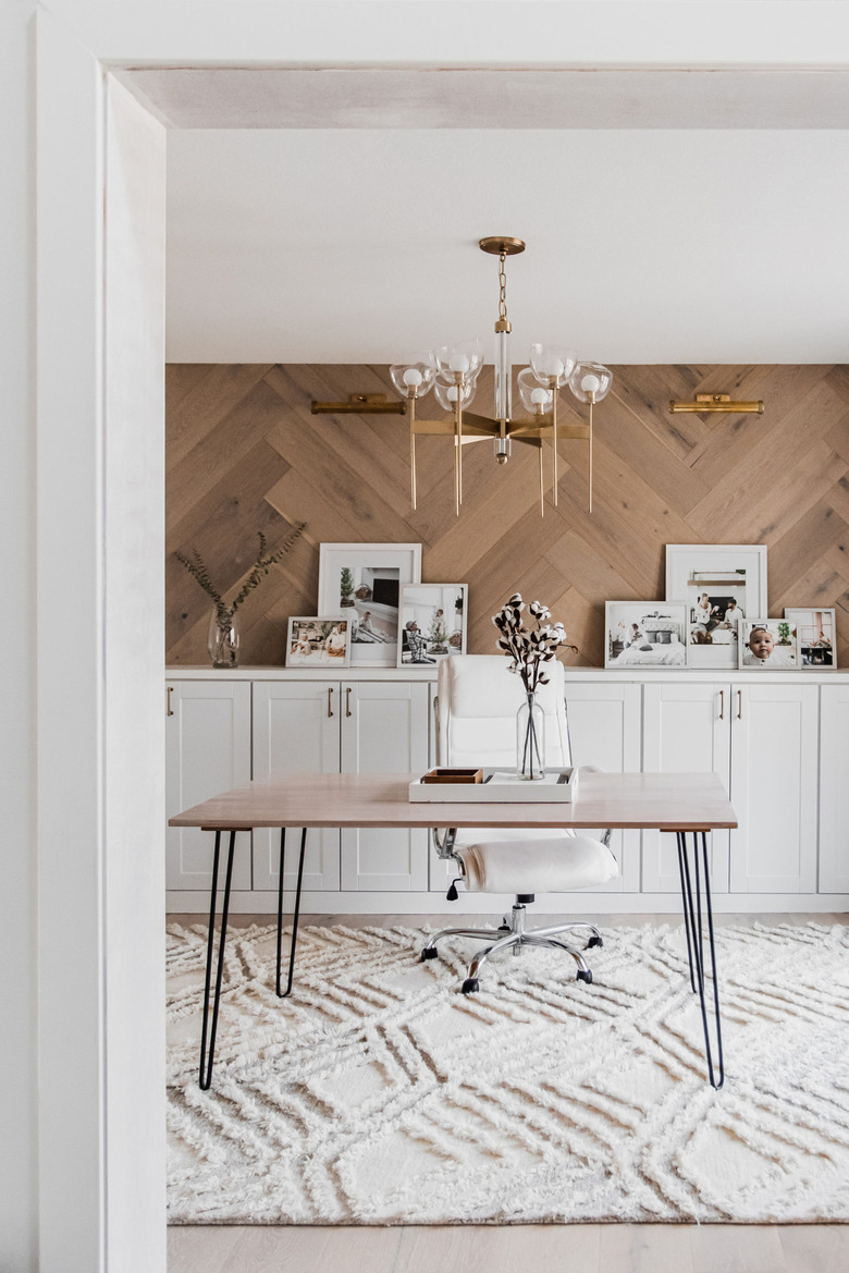 brass picture lights on wood herringbone wall in modern farmhouse office