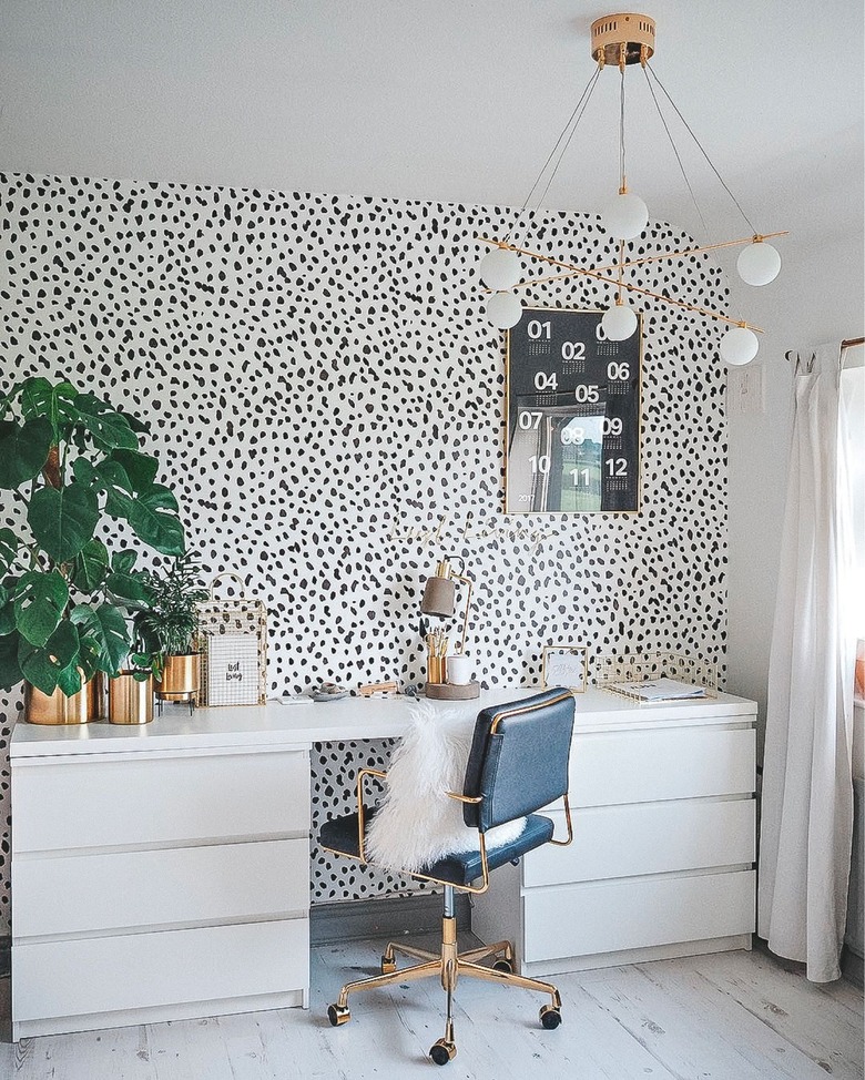 black and white home office with glam furniture and chandelier