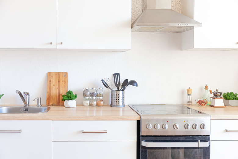 Scandinavian classic minimalistic kitchen with white and wooden details. Modern white kitchen clean contemporary style interior design