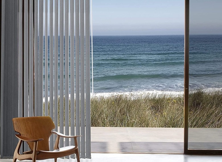 Open vertical blinds and sliding glass door, view of beach, ocean