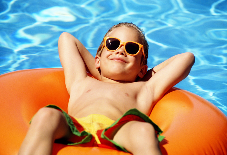 Boy floating in swimming pool