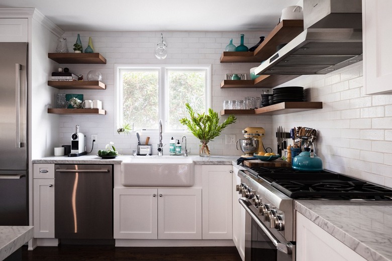 Kitchen with white subway tile, stainless range, open shelves