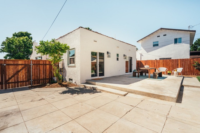 A patio paver outside a white Mediterranean-style house