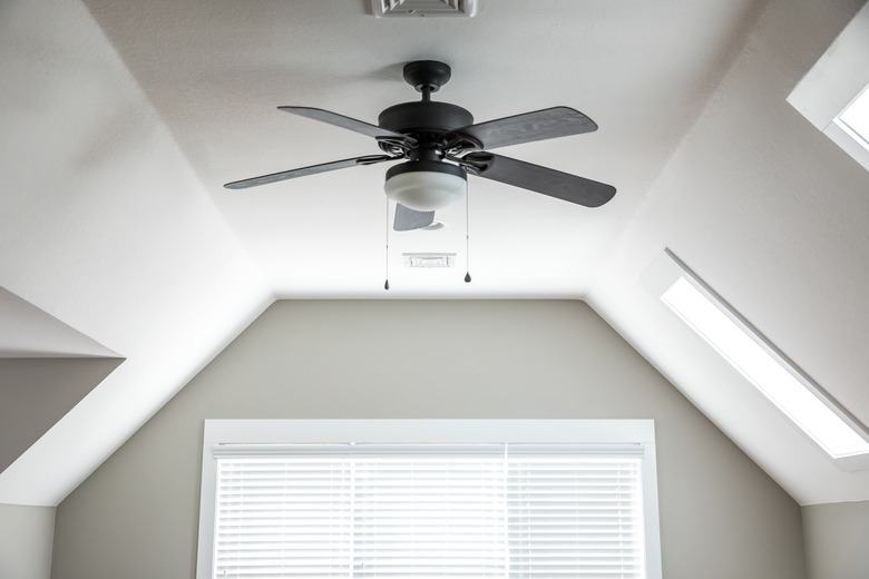 Open and airy bonus room game room in a new construction house with a dark wood ceiling fan, a window and blinds