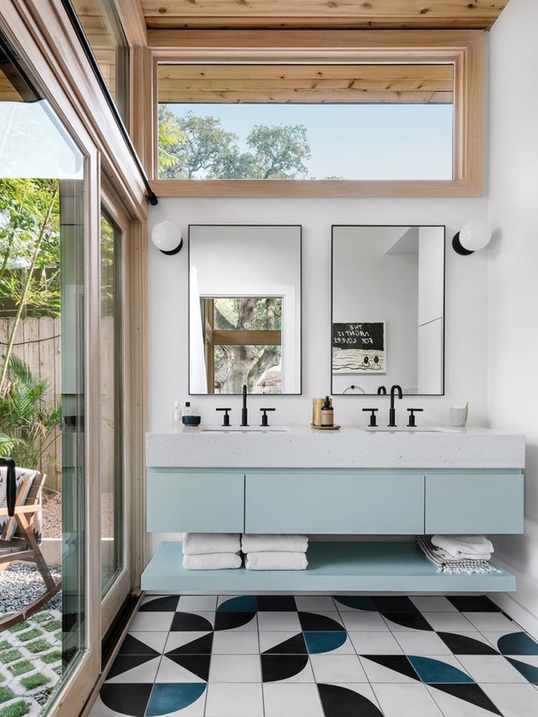 minimalist with color in white bathroom with blue vanity