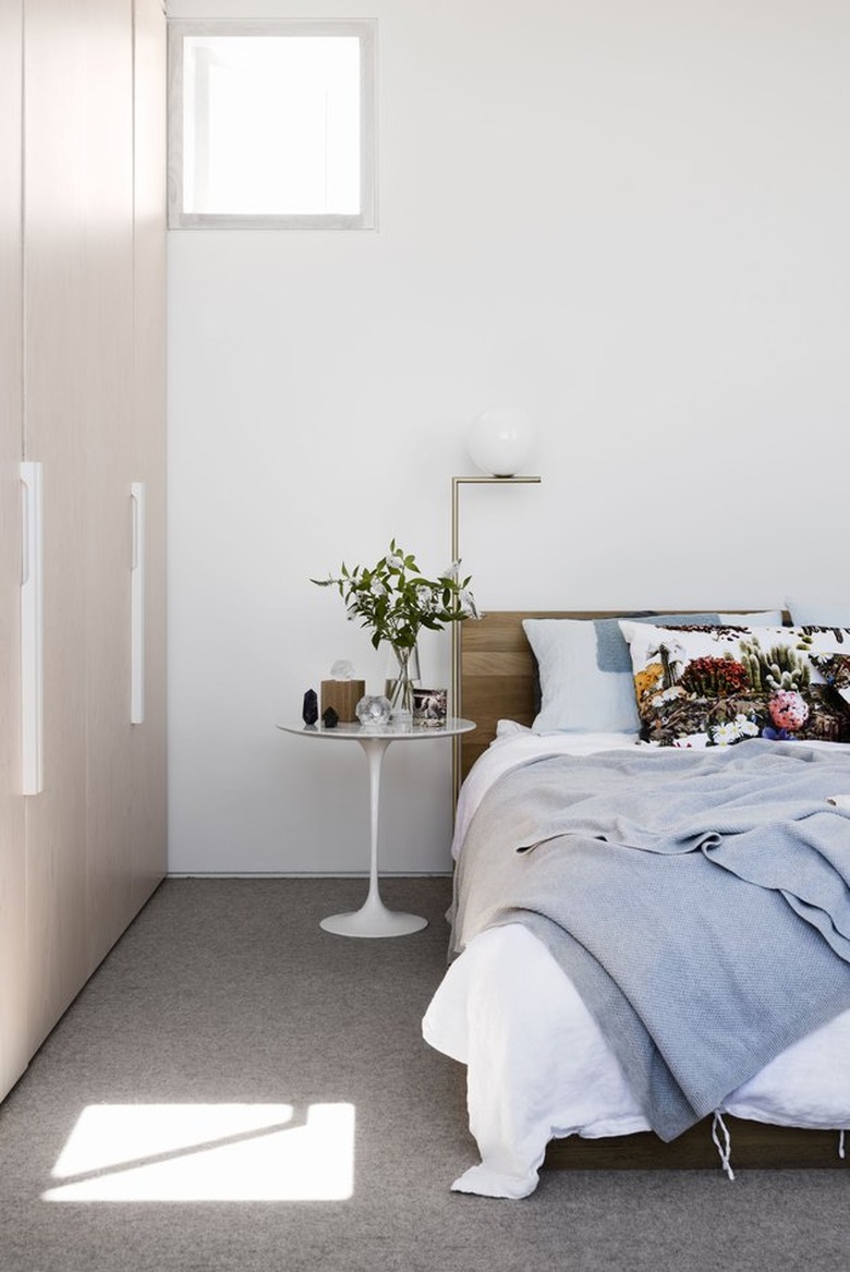 minimalist with color in white room with bed