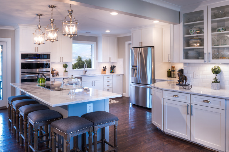 Well-designed white kitchen with white countertop