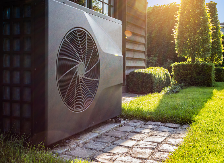 Air heat pump near pool house outdoors.