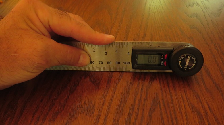 A digital protractor against a table.