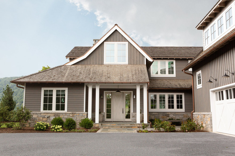 How to Choose Exterior House Colors on taupe house with white window trim and wide driveway