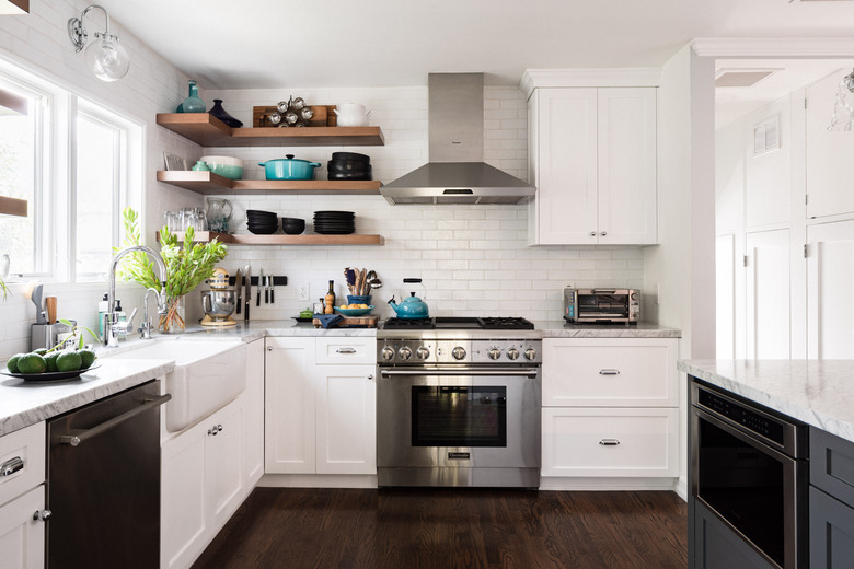 airy kitchen with exposed shelves, dark wood floor, white cabinetry, white tile backsplash