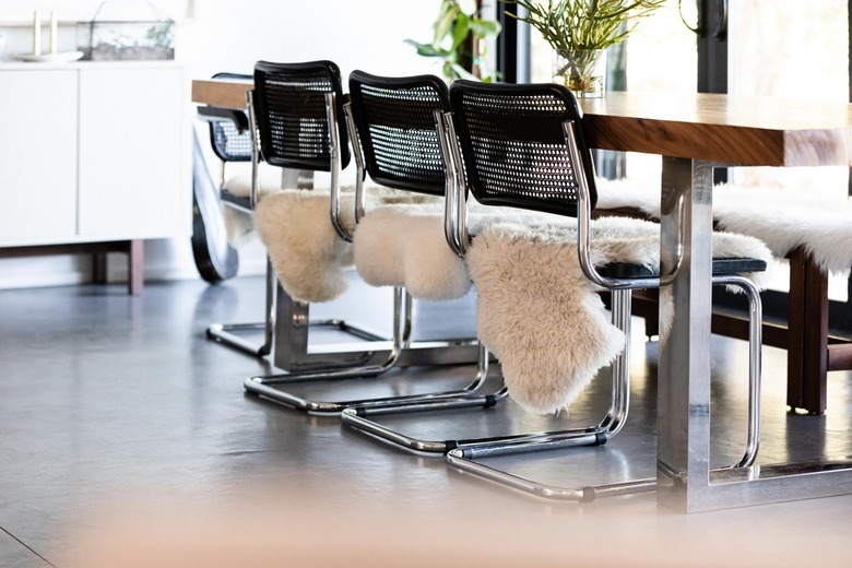 Dining room black and metal chairs with sheepskin