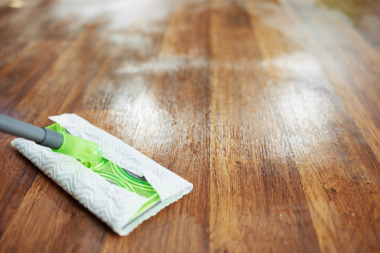 Closeup of mop and hardwood floor.