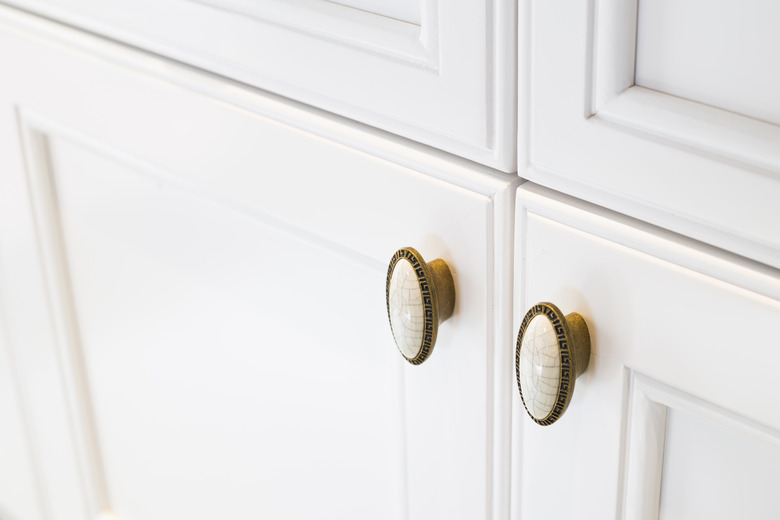 white closet with copper handles