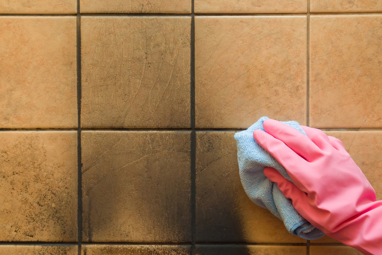 Cleaning soot off  a wall.