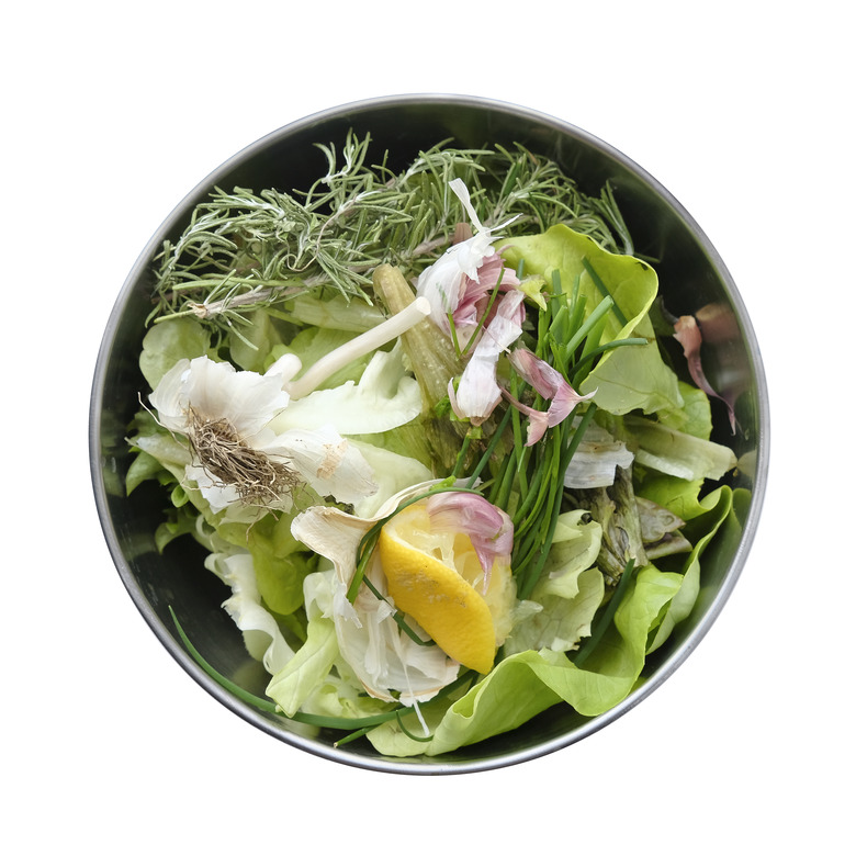 A bowl of kitchen waste, organic garbage (vegetables, herbs)