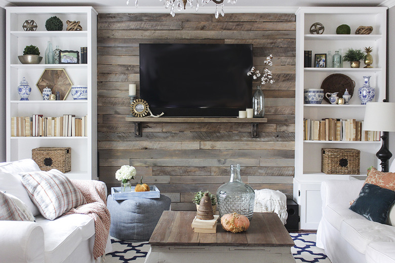 Wood pallet accent wall between two bookshelves