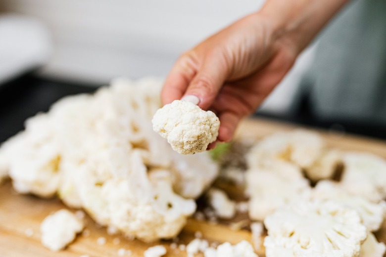 Hand holding cauliflower floret