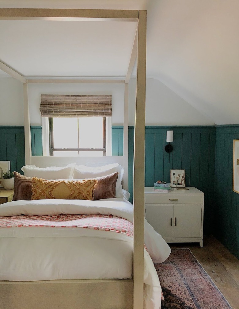 canopy bed in bedroom with slanted walls