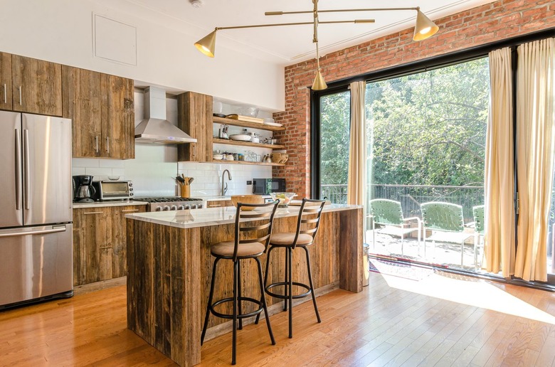 rustic kitchen wood cabinets floor to ceiling windows