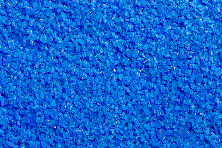 full frame background and texture of blue copper sulfate granules - close-up