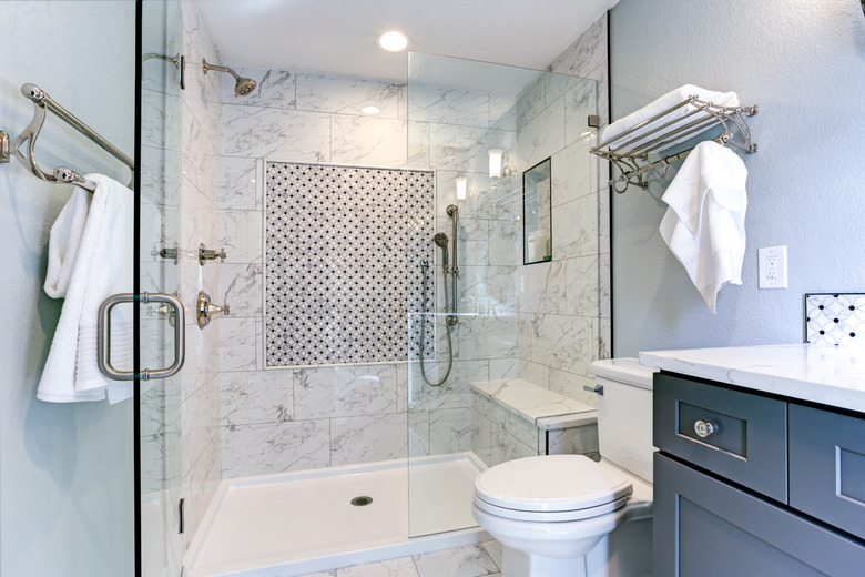 New blue bathroom design with marble shower surround.