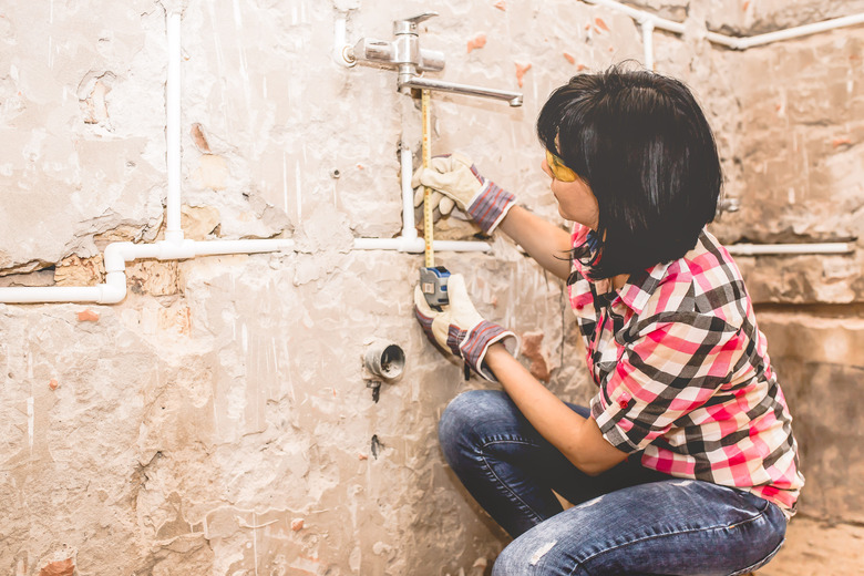 Woman using  tape measure.