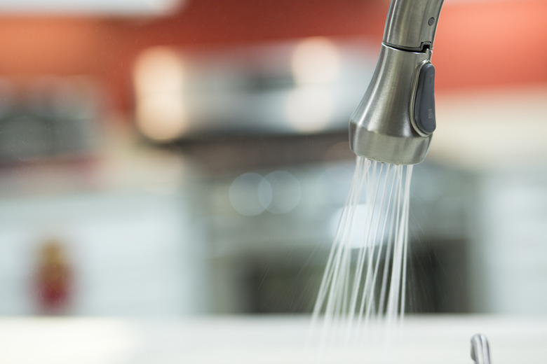 Water pouring out of kitchen faucet