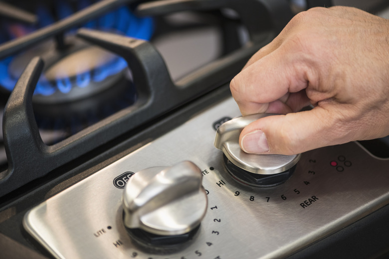 USA, New Jersey, Jersey City, Close-up of hand adjusting stove burner