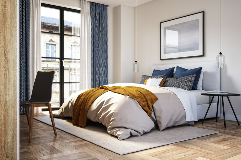 Modern bedroom with large windows and drapes