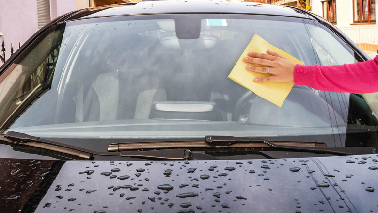 Cleaning  windshield.