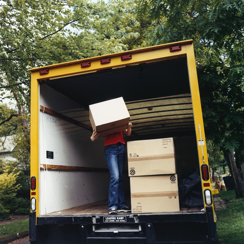 Woman in Truck Holding Box