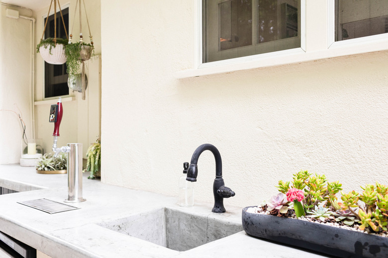 outdoor kitchen sink with black faucet