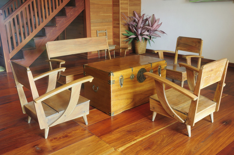 teak wood console table and armchair on wooden floor