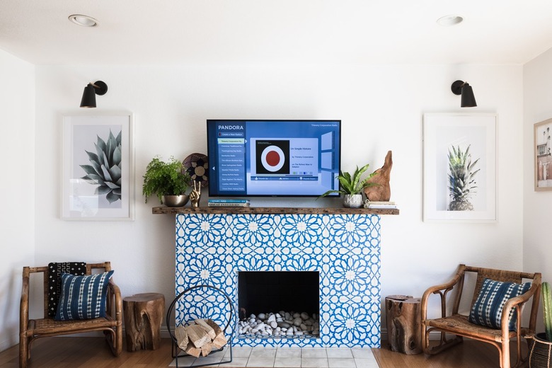 Blue Moroccan star tile fireplace, with a wood mantel, and Boho wood chairs with Shibori pillows.