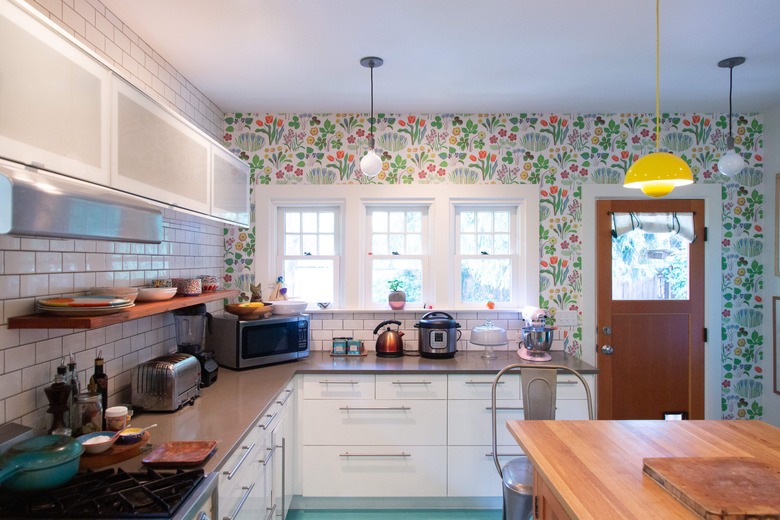 kitchen with floral wallpaper and subway tile backsplash