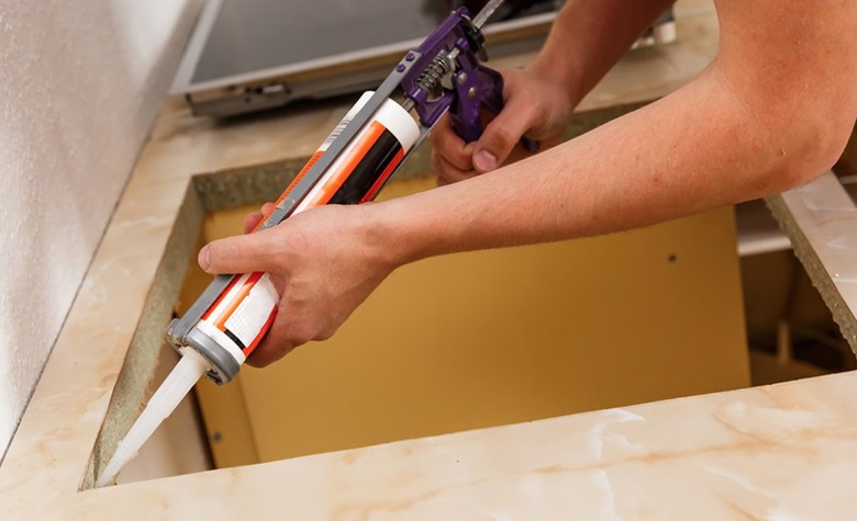 Undermount sink being caulked